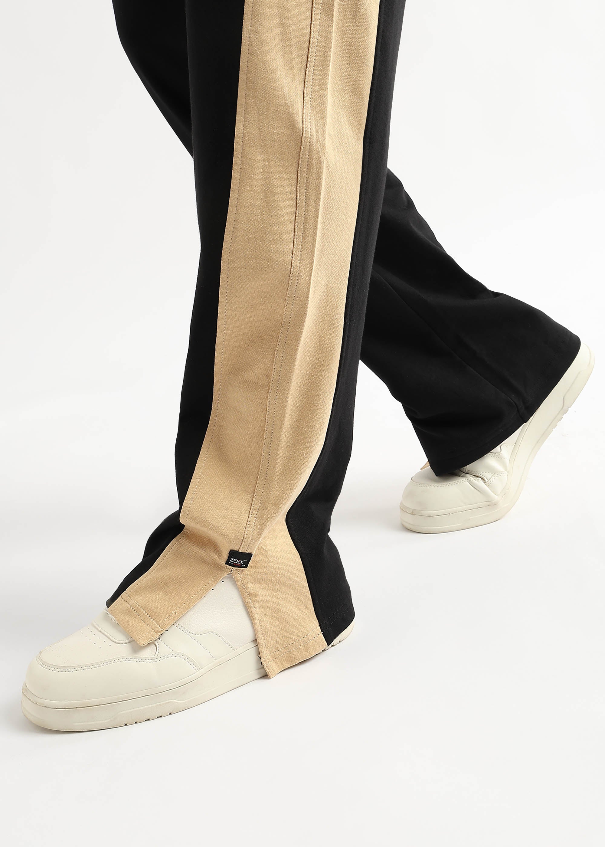 Trendy black joggers with beige-golden accents