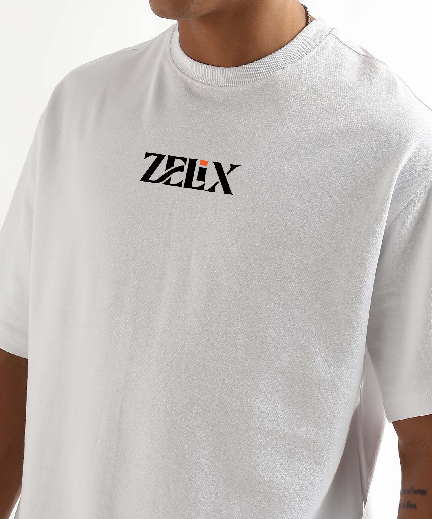 White t-shirt with 'Zelix' logo worn by a person