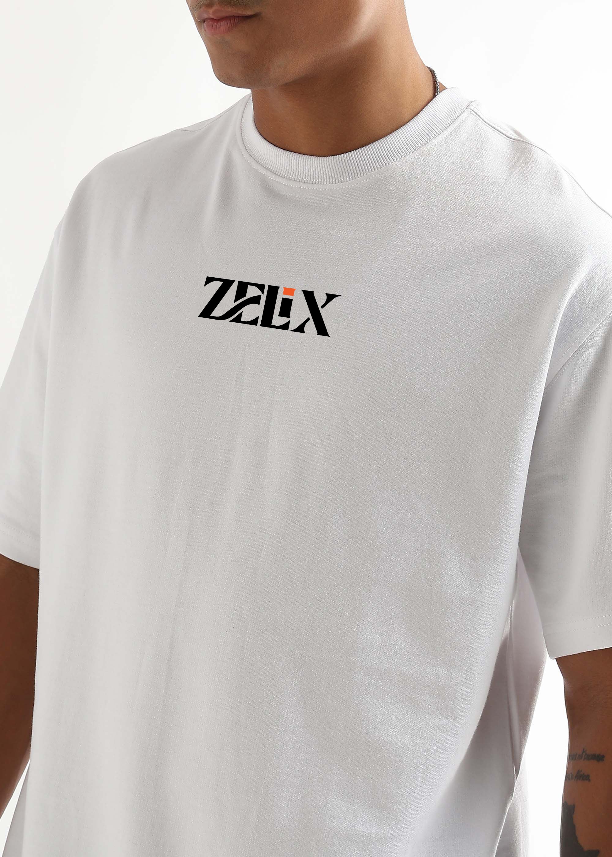 White t-shirt with 'Zelix' logo worn by a person