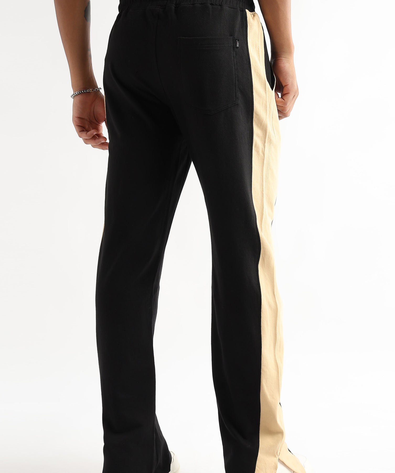 Tapered black jogger pants with beige side slit
