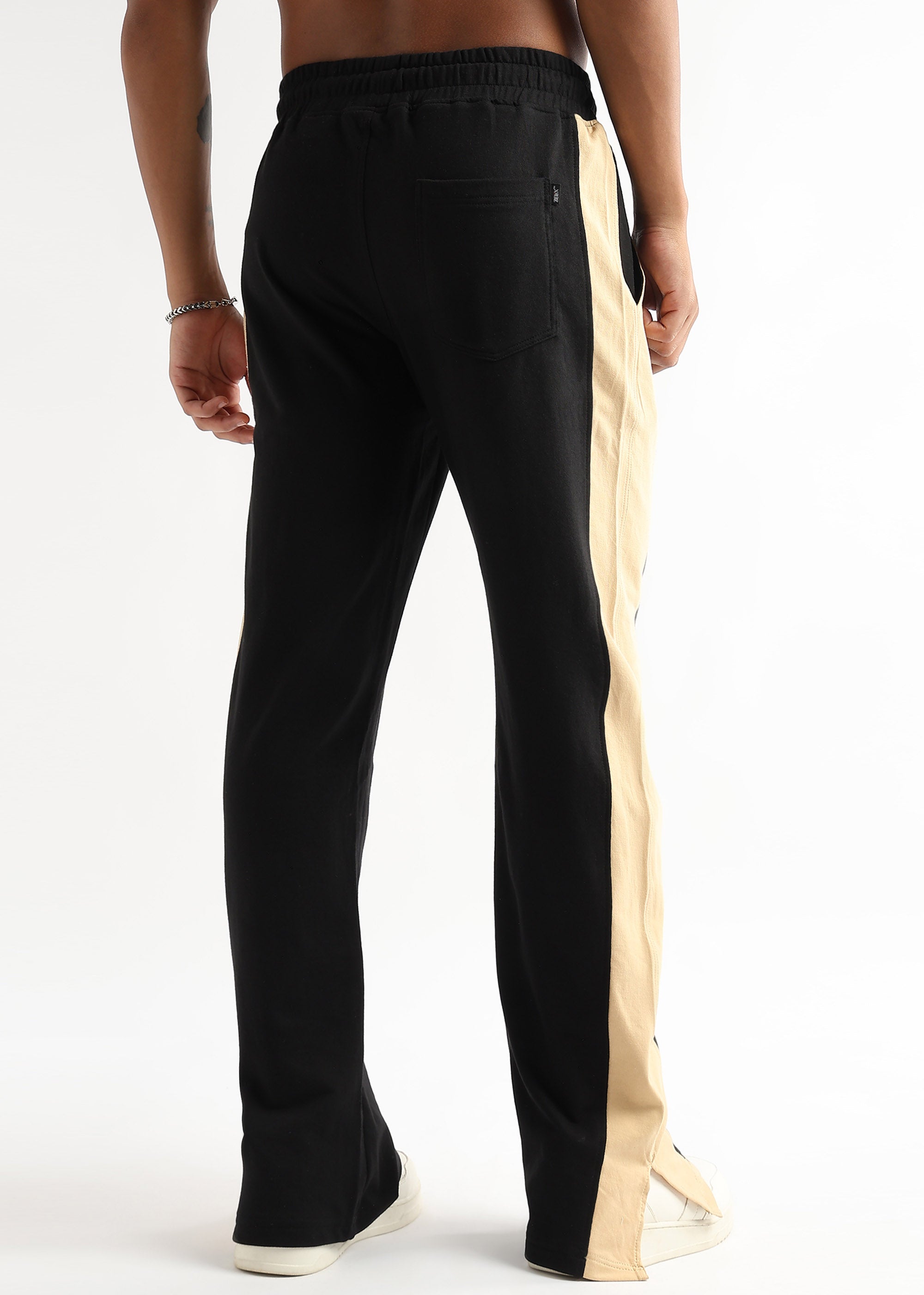 Tapered black jogger pants with beige side slit