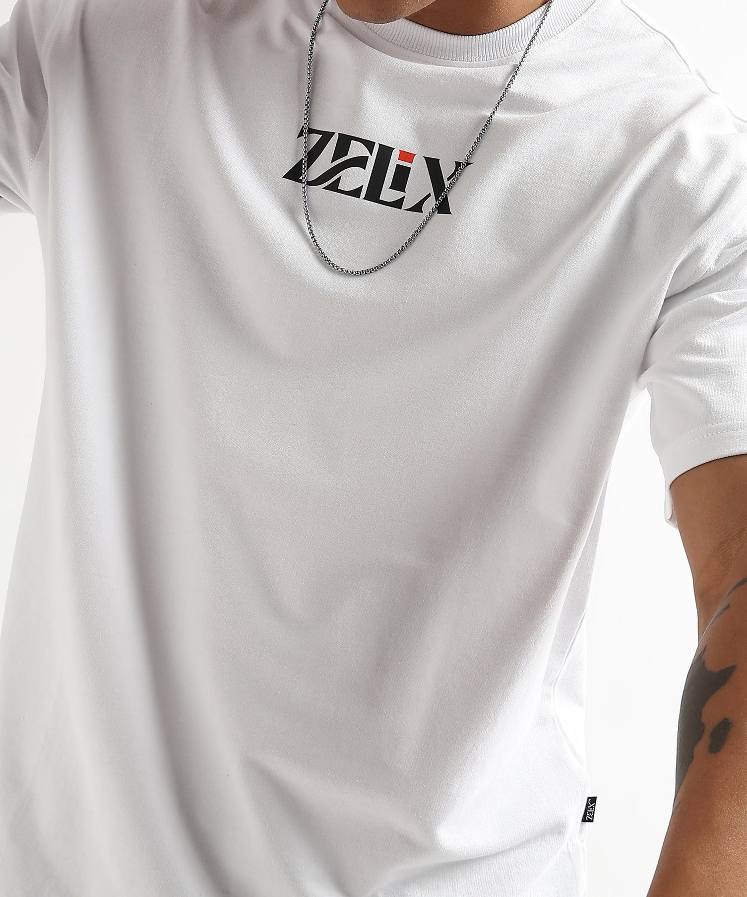 White oversized Wings of Belief fashion graphic shirt