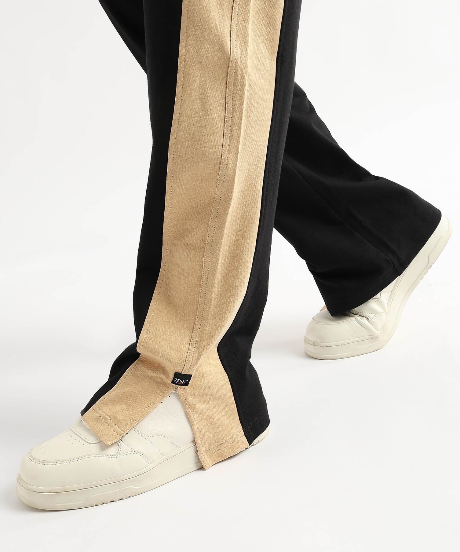 Trendy black joggers with beige-golden accents