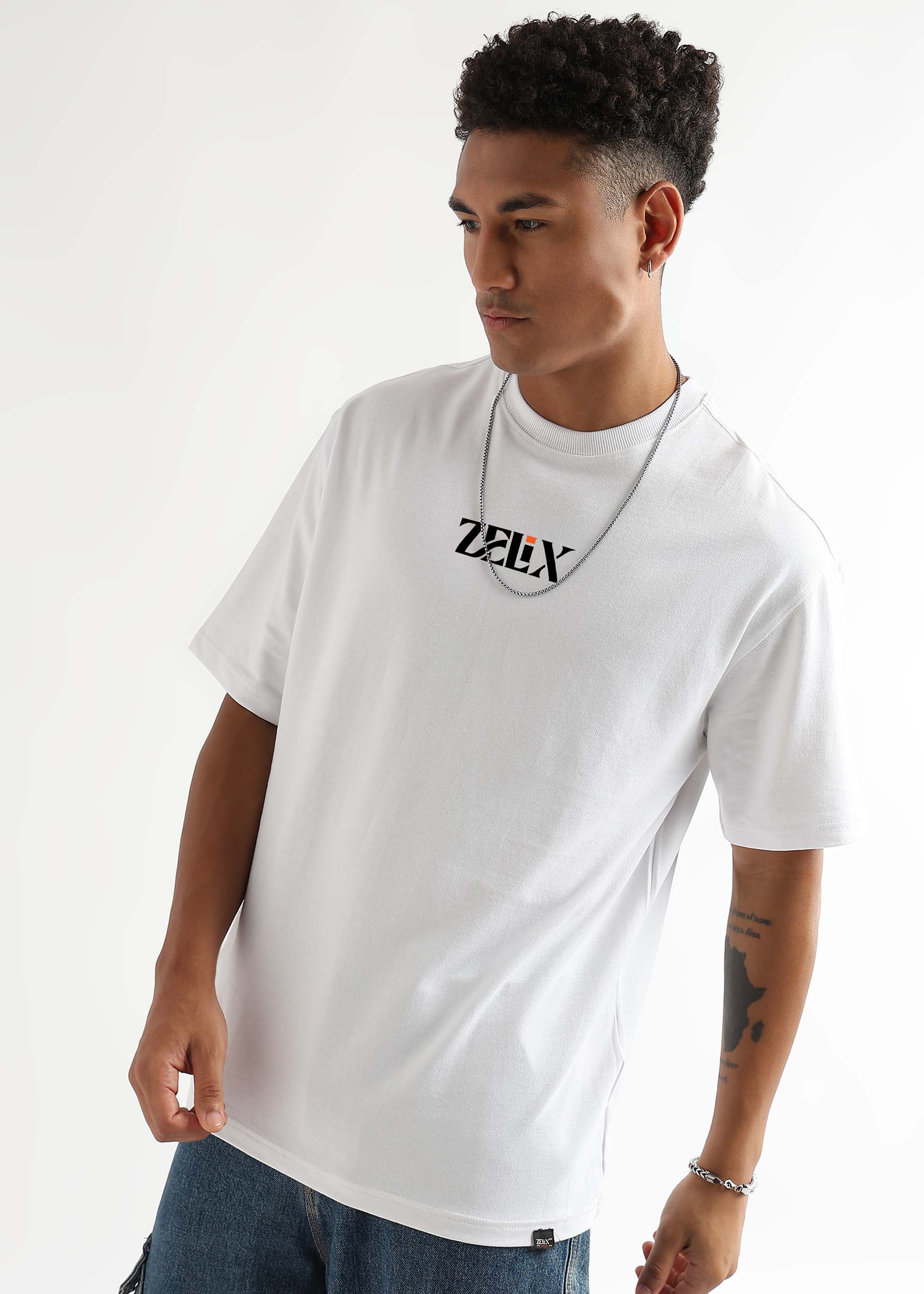 Man wearing a white t-shirt with a logo on a plain background